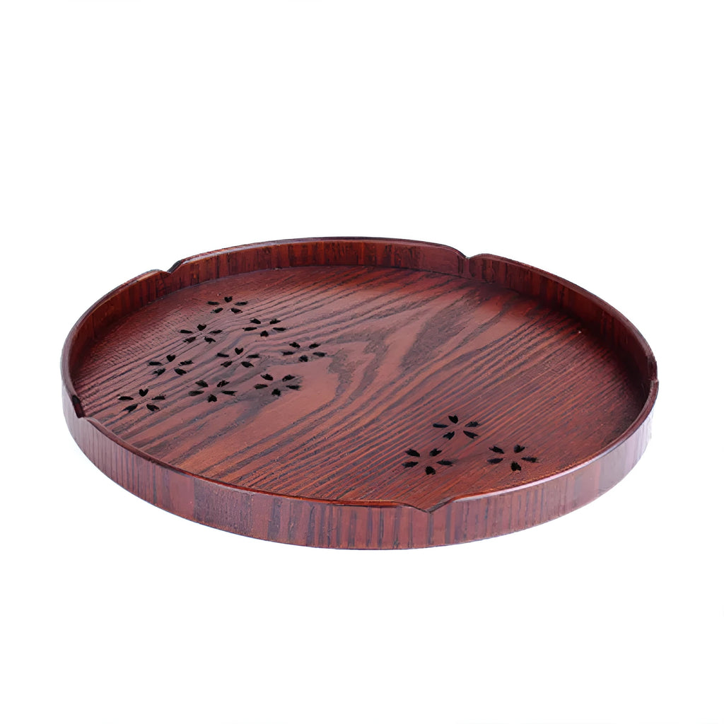 Twelve wooden dessert plates with hollow cherry blossom pattern arranged in set