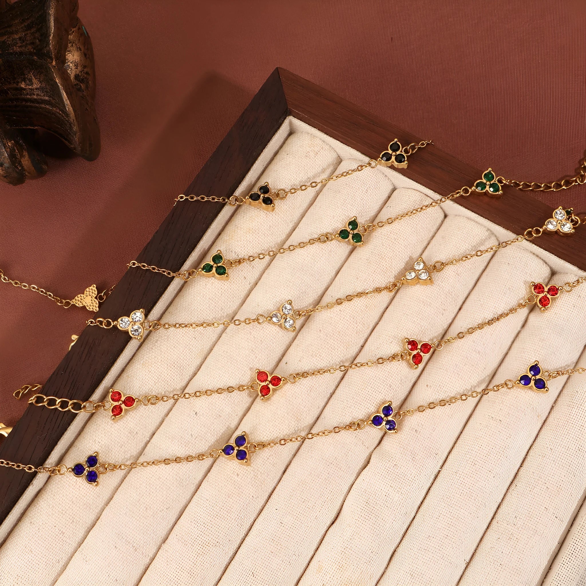 Women's stainless steel geometric bracelet with triangle details and a coloured stone setting.