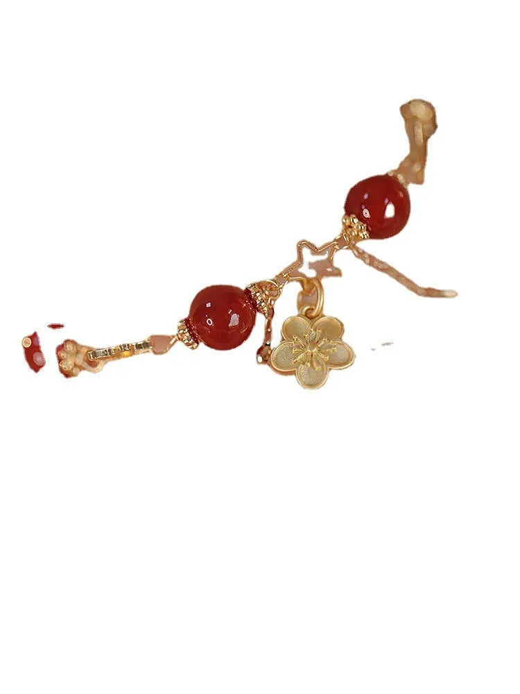 Handmade red agate double layer bracelet with floral peach blossom design on a white background.