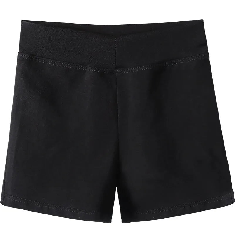 Black cotton dance shorts for women laid flat, showing solid colour and simple design for ballet practice.