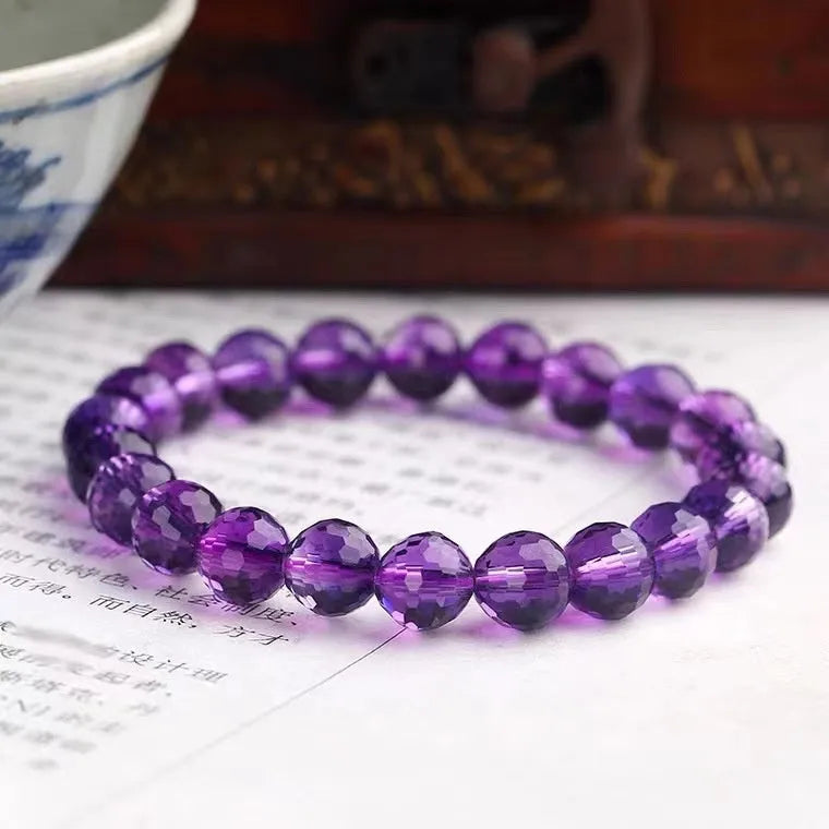 Handmade ametrine bracelet with 128-facet crystal beads in a choice of diameters and symbolic designs.