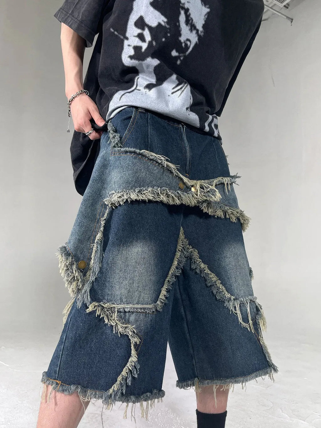 Blue denim shorts with frayed five-pointed star design and loose fit