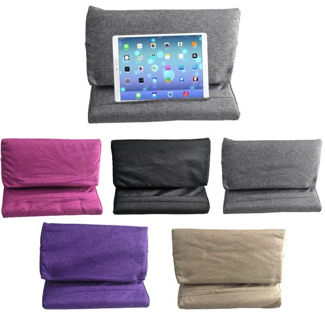 Candy-shaped tablet and phone support pillow with slow rebound fill, beige colour, on a bed