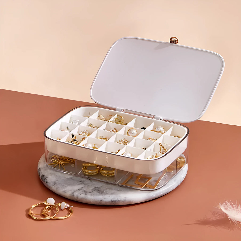 Green minimalist jewellery storage box with multiple internal compartments for rings and earrings.