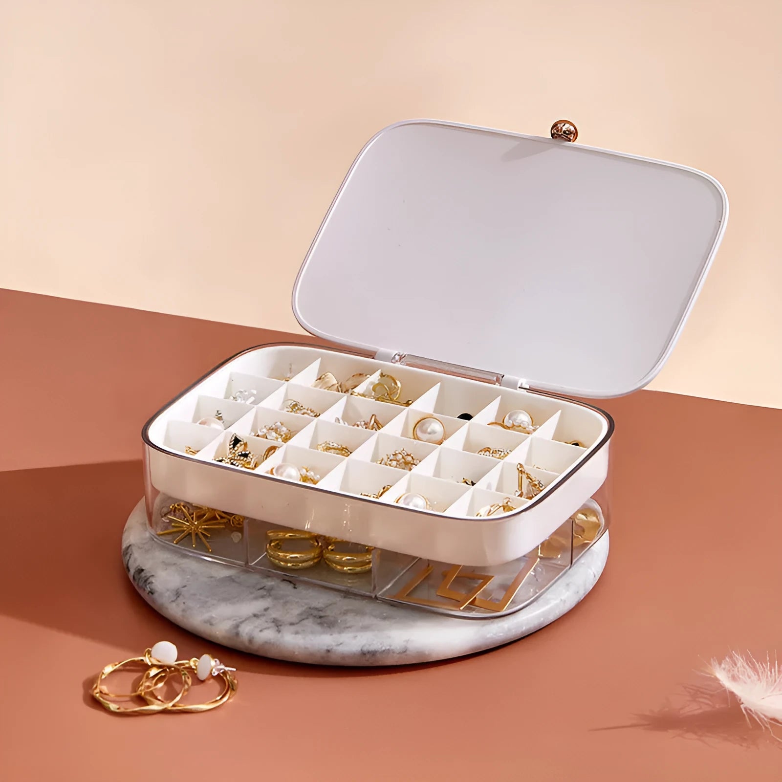 Green minimalist jewellery storage box with multiple internal compartments for rings and earrings.