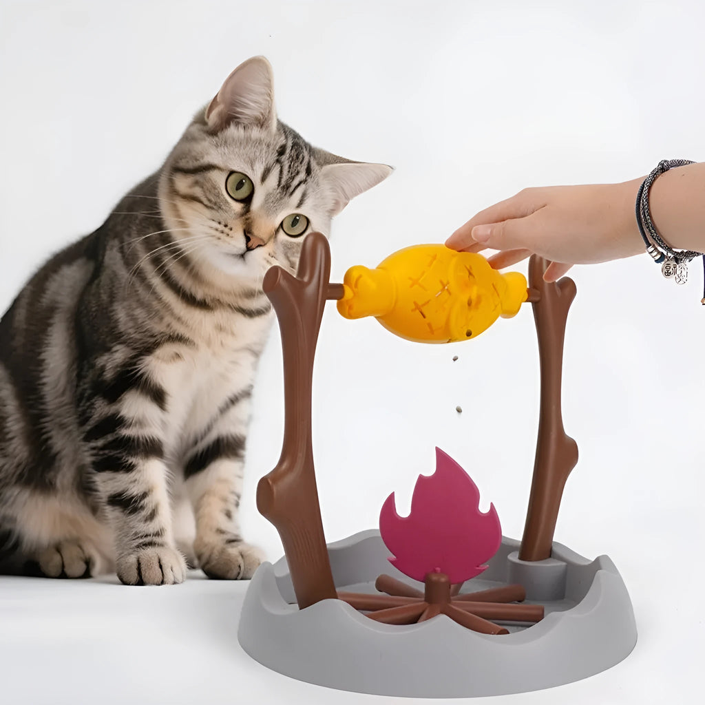 Tumbling barbecue-style cat feeder toy with leakage food dispenser, shown in plastic construction.