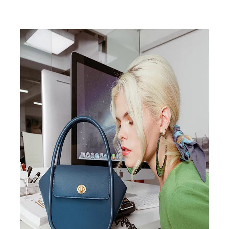 Women's leather wing tote bag with cross-body strap and latch closure in various colour options