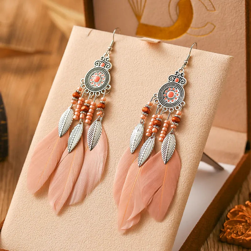 Round drop feather earrings with leaf patterning in alloy, available in multiple electroplated colours.