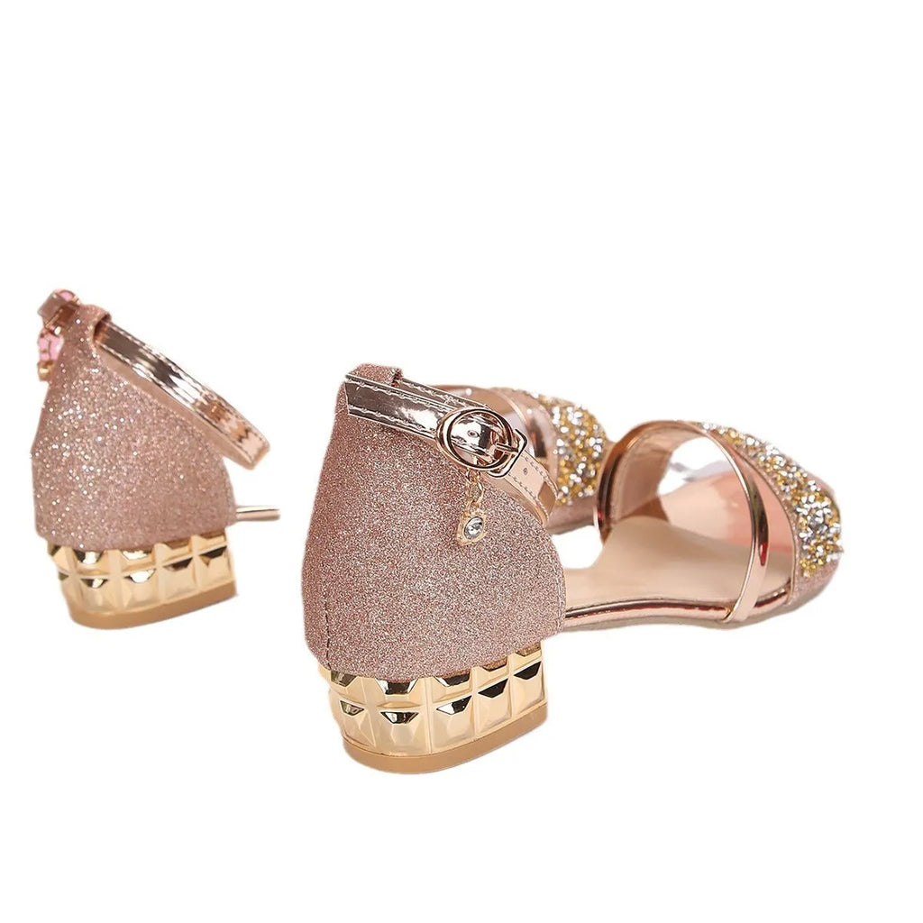 Women's Roman-style sandals with rhinestones, buckle strap, and fish-mouth toe in black, gold, or silver.