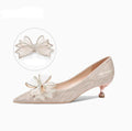 Women's champagne gold sequinned pointed-toe pumps with a stiletto heel on a rubber sole.
