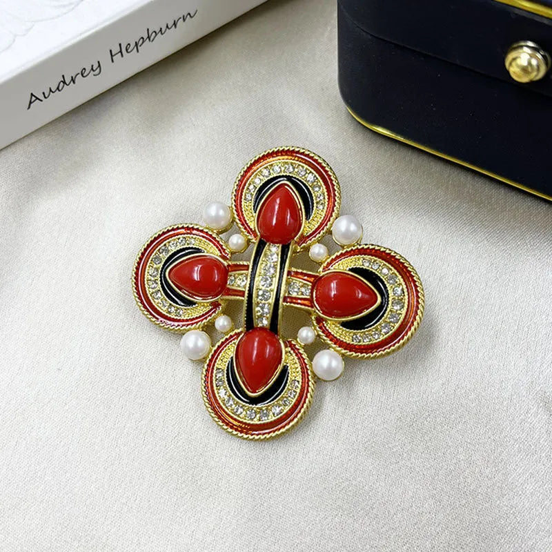 Close-up of a vintage medieval baroque cross brooch with crystals, made from zinc alloy.