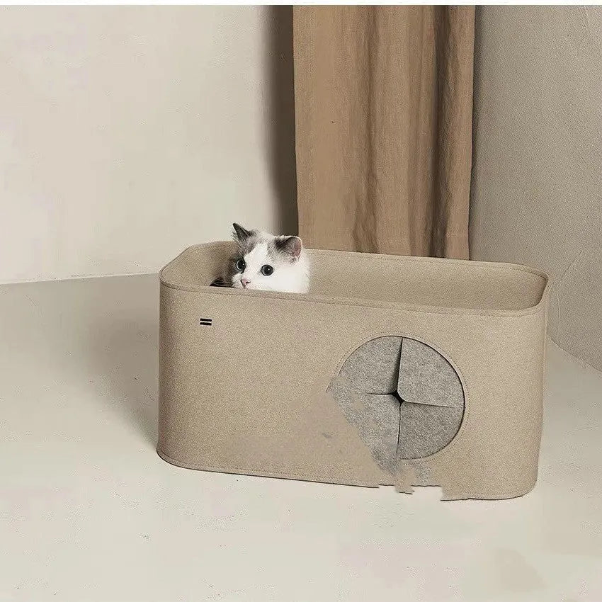 Grey foldable felt cat nest bed showing its size next to a cat.