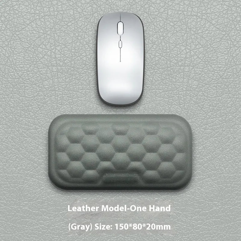 Grey and black memory foam mouse wrist pads with silicone bases, shown in cloth and leather cover options.