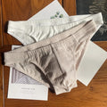 Men's solid colour cotton triangle briefs in apricot, shown from the front on a mid-waist fit model.