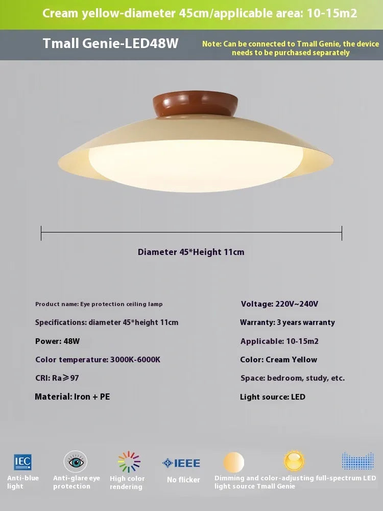 Modern minimalist cream style flying saucer ceiling lamp in mint green on a white ceiling.