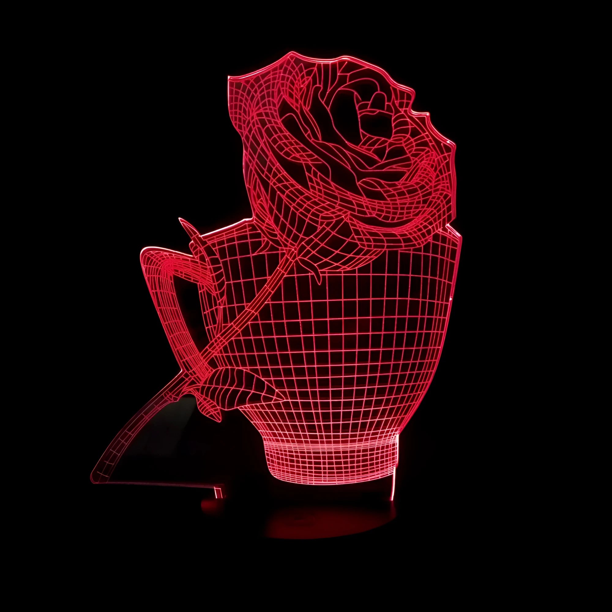 3D rose flower decorative night light with remote control on a bedside table.