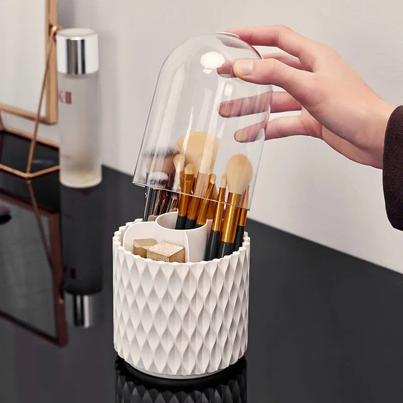 White rotating transparent makeup brush storage tube with dust cover lid on desktop