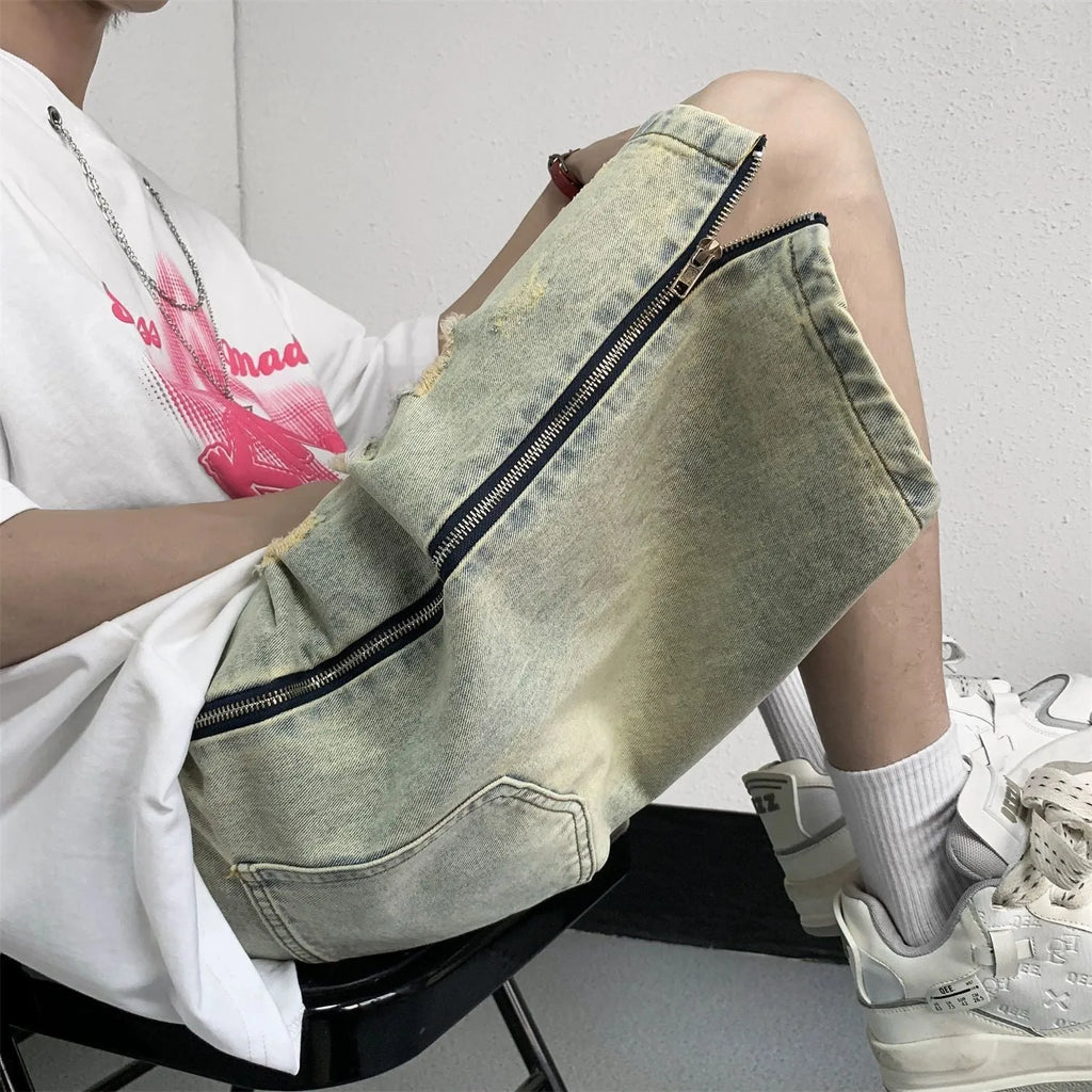 Blue retro denim shorts for men with ripped detail, loose five-points fit, and button fly closure.