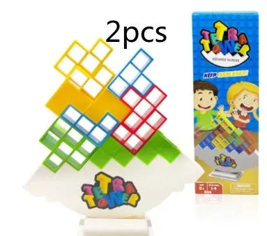 Plastic balance stacking board game with 16 coloured building blocks, chassis, and base on table.