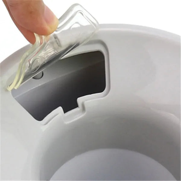 White plastic tennis food reward machine for interactive dog training with snack dispensing