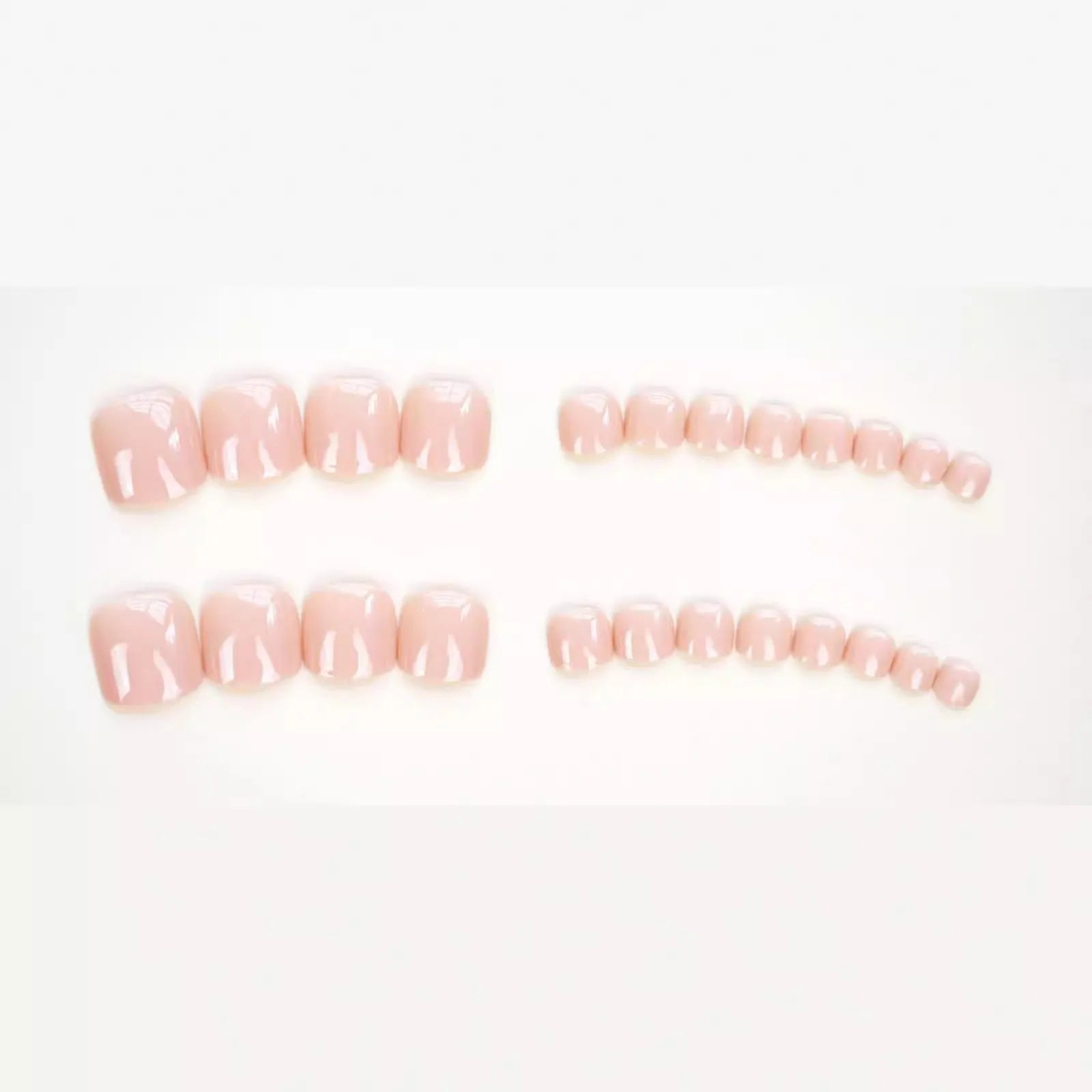 Set of ten skin-colour plastic artificial toenails and a bottle of glue for pedicure enhancement.