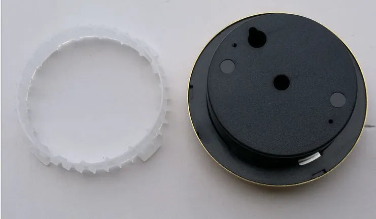 Circular analogue thermometer and hygrometer with aluminium outer ring and dial showing temperature and humidity scales