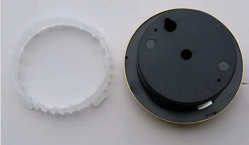 Circular analogue thermometer and hygrometer with aluminium outer ring and dial showing temperature and humidity scales