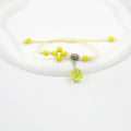 Close-up of a hand-woven glass bracelet with large beads containing real dried flowers and a lace design.