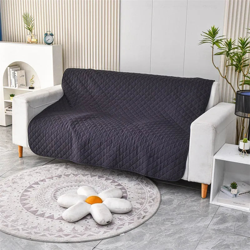 Reversible dog blanket sofa cover in grey and cream colours laid flat on a sofa