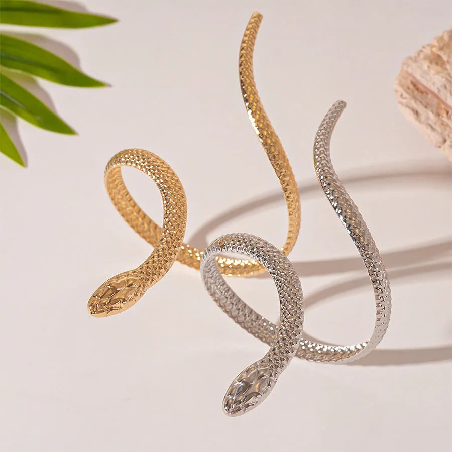 Gold exaggerated twisted snake ring and bracelet jewellery set on display