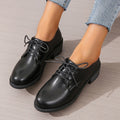 Black women's low-top work shoes with a chunky heel, rounded toe, and soft rubber sole.
