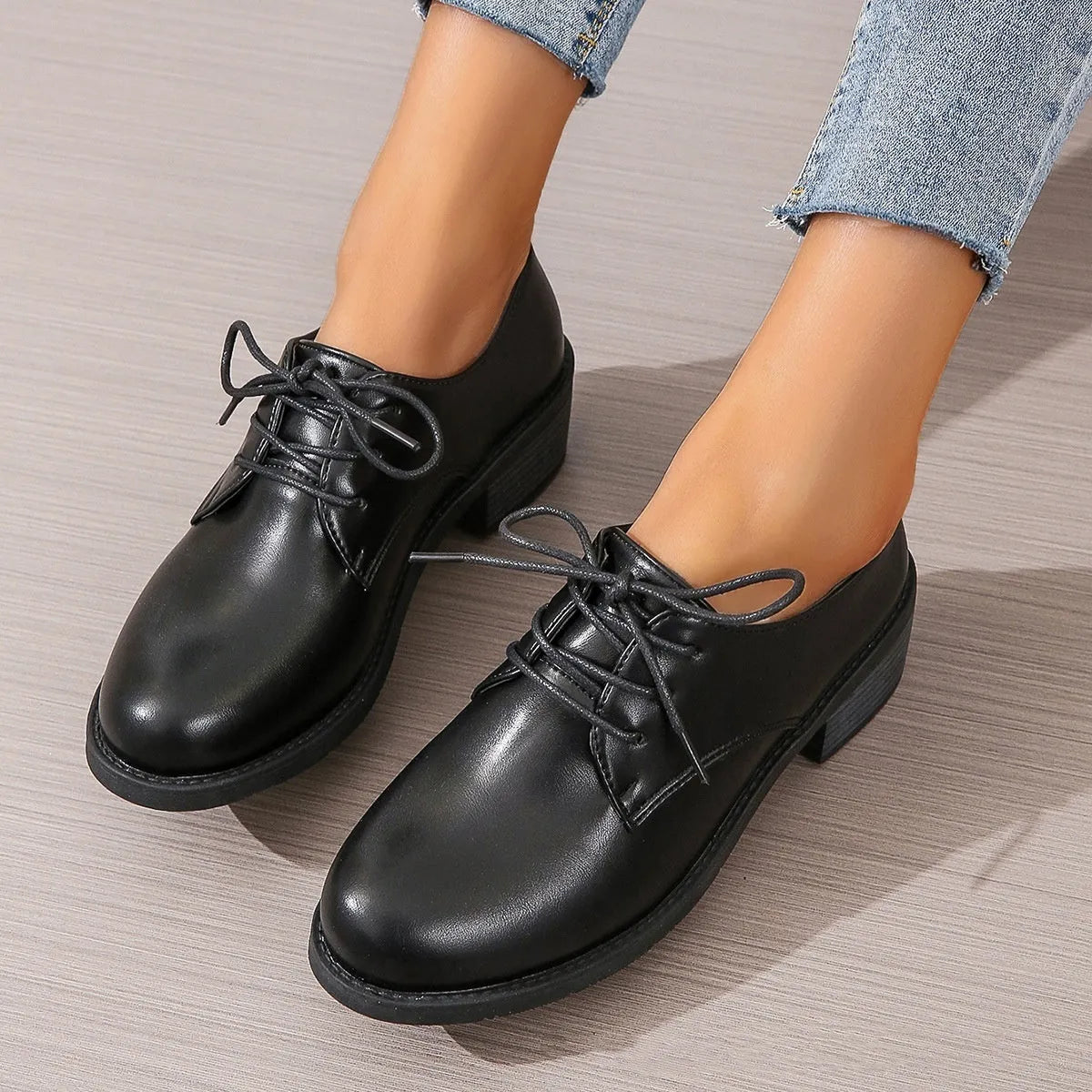 Black women's low-top work shoes with a chunky heel, rounded toe, and soft rubber sole.