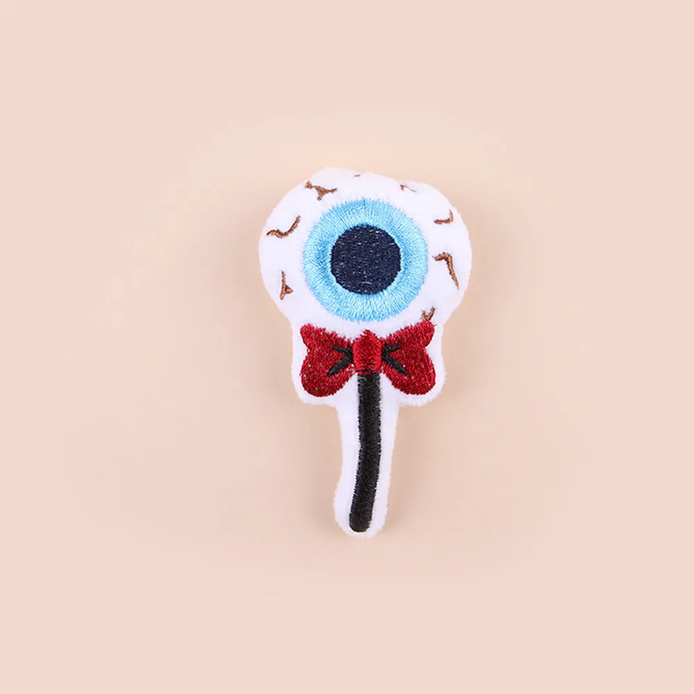Small cat teaser wand with dangling plush candy, eye, and skull toy attachments