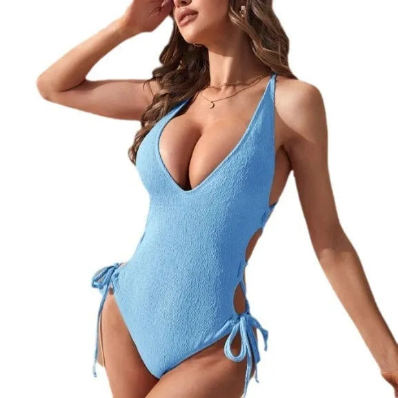 Women's black hollow backless one-piece tether bikini swimsuit on a model.