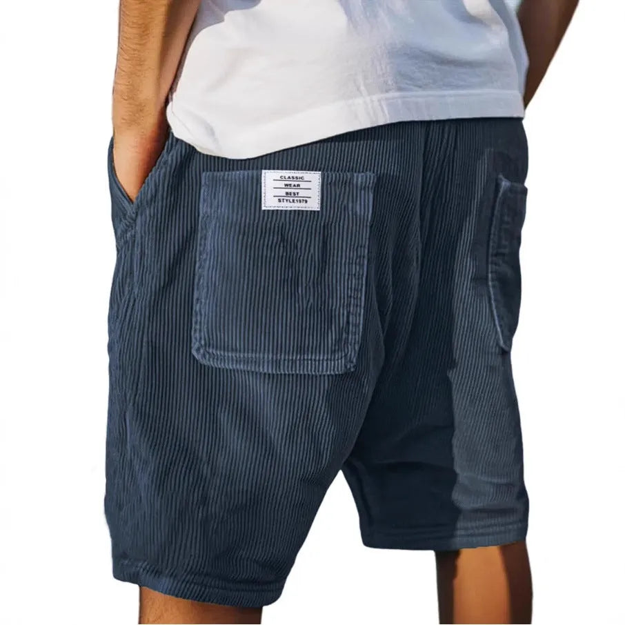 Men's grey straight-fit corduroy shorts with multiple pockets and a small embroidered logo on the leg.