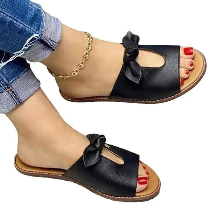 Ladies fish mouth style sandals with a decorative bow on the artificial PU upper, shown in black.