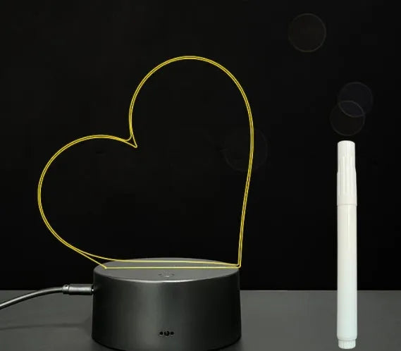 Black 3D acrylic LED message board night light with remote control and pen on desk