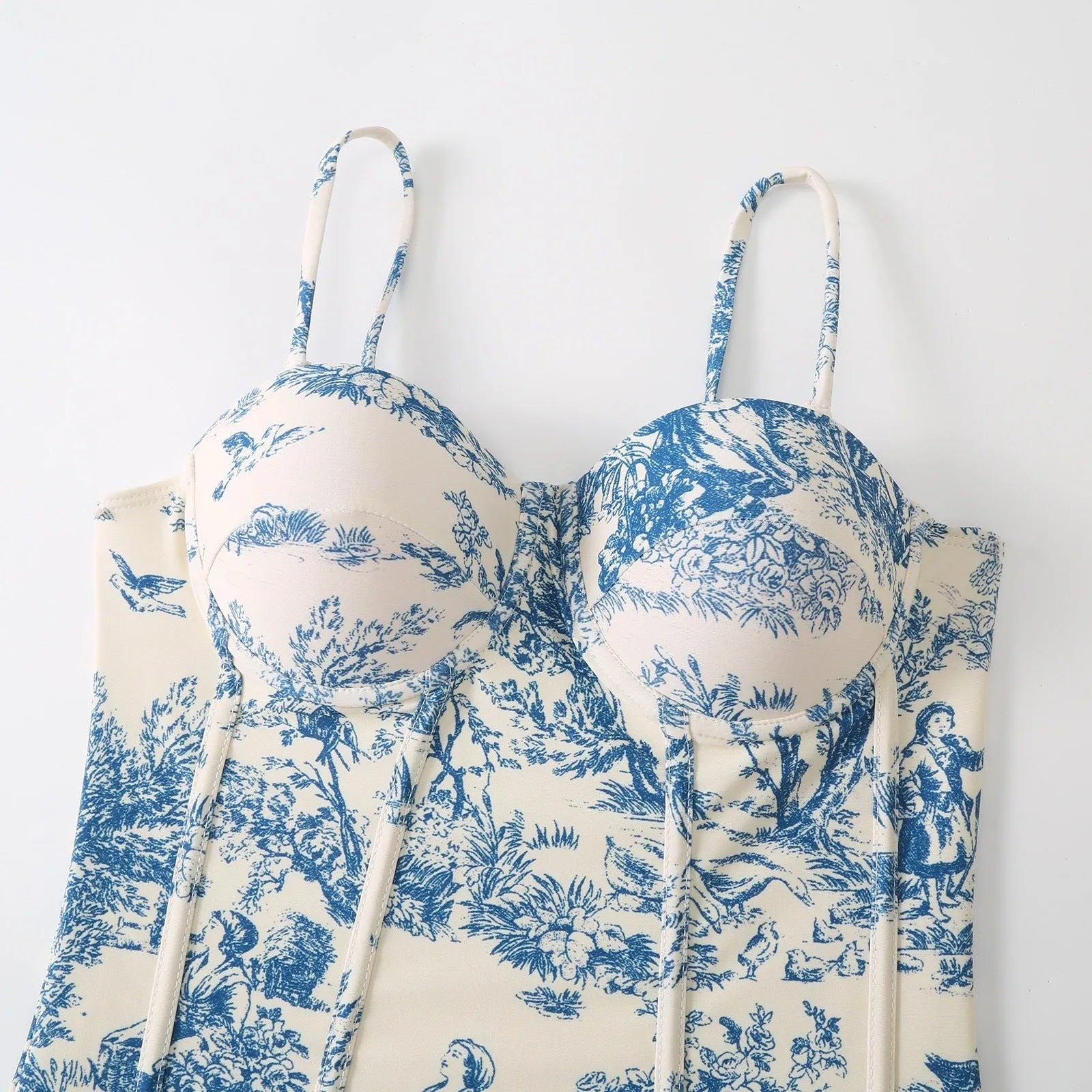 Blue patterned women's one-piece swimsuit shown with a matching light gauze skirt.