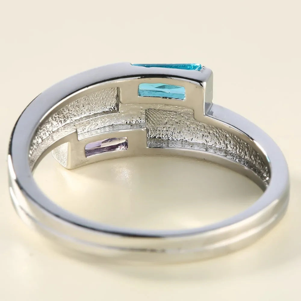 Silver electroplated copper ring with a zircon inlay, shown in a unisex design.