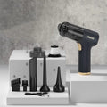 Black wireless handheld car vacuum cleaner with multiple nozzle attachments on a white background.