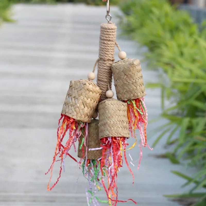 Colourful parrot chew toy with wood base, sisal rope and blue shredded paper attachments