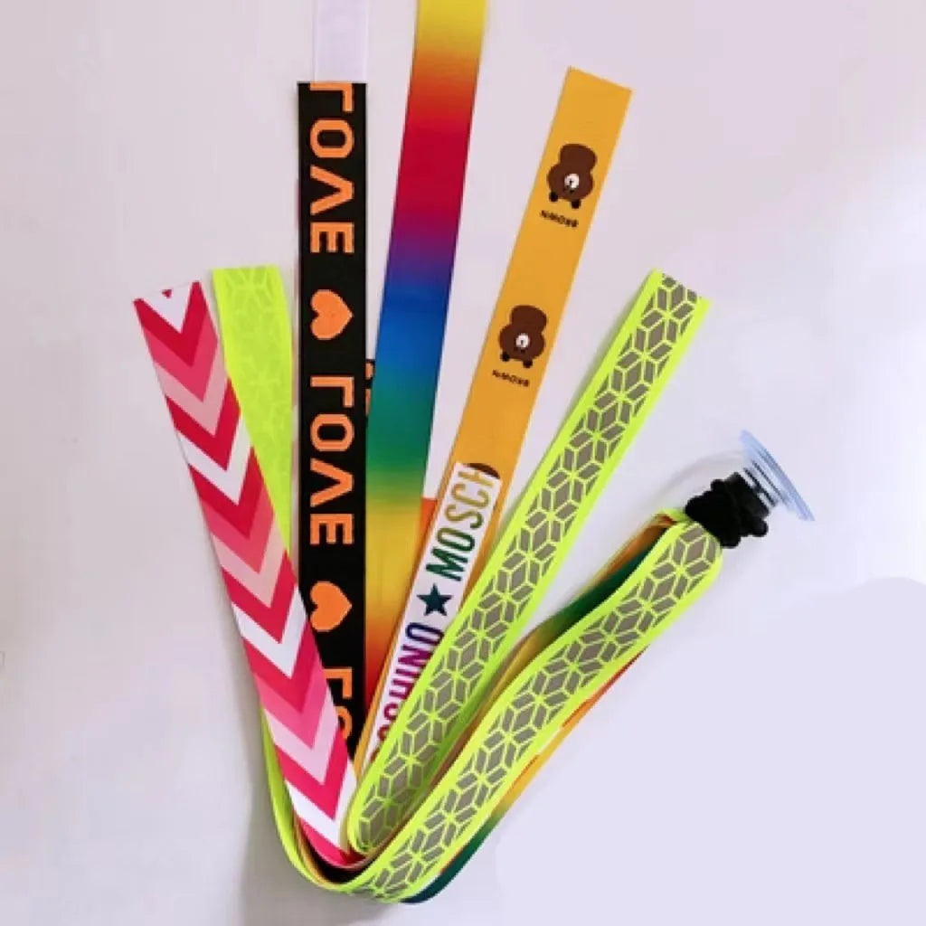 Colourful fabric helmet streamers for children's roller skating and ski helmets, shown in apricot, red, and grey.
