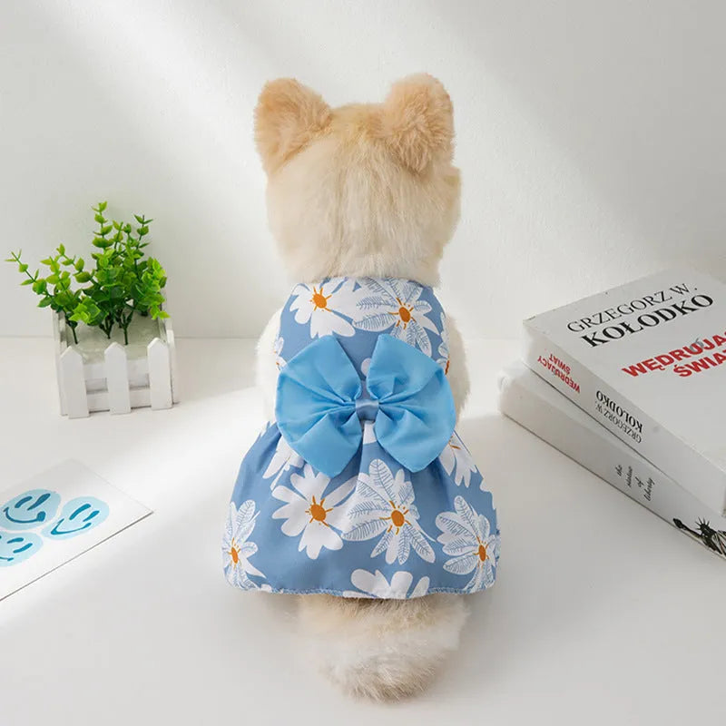 Orange floral butterfly pet dress with a bow on a dog, showing thin summer clothing.