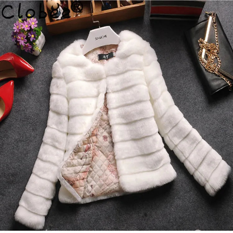 Women's short faux fur top in beige on a hanger, showing regular sleeves and textured fabric.