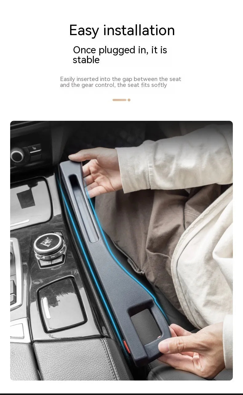 Black plastic car seat gap storage organiser box with handle inserted between car seat and centre console.