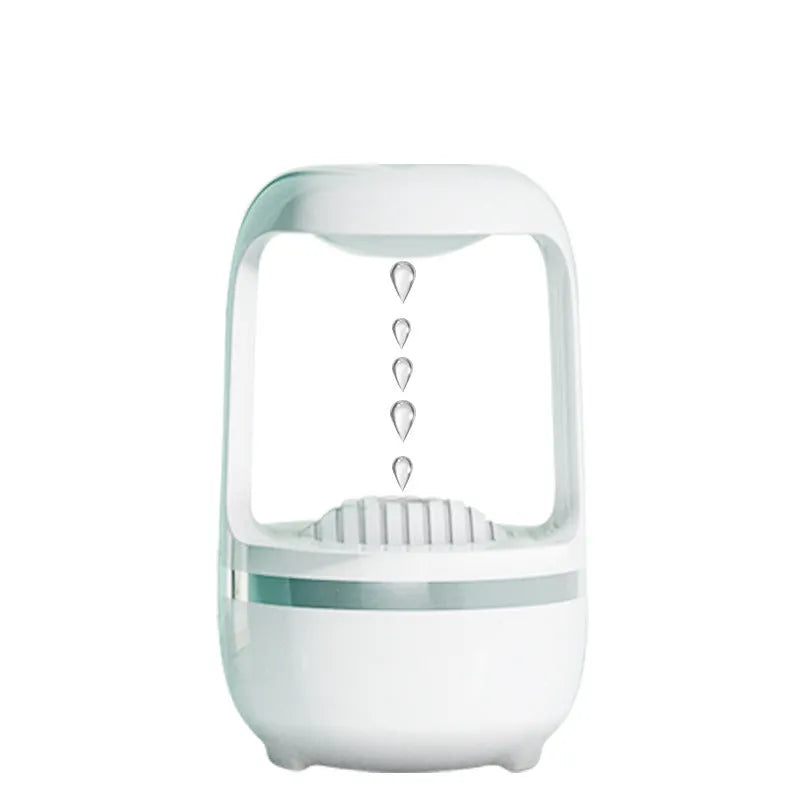 White anti-gravity humidifier showing floating water droplets on a desk next to a USB cable.