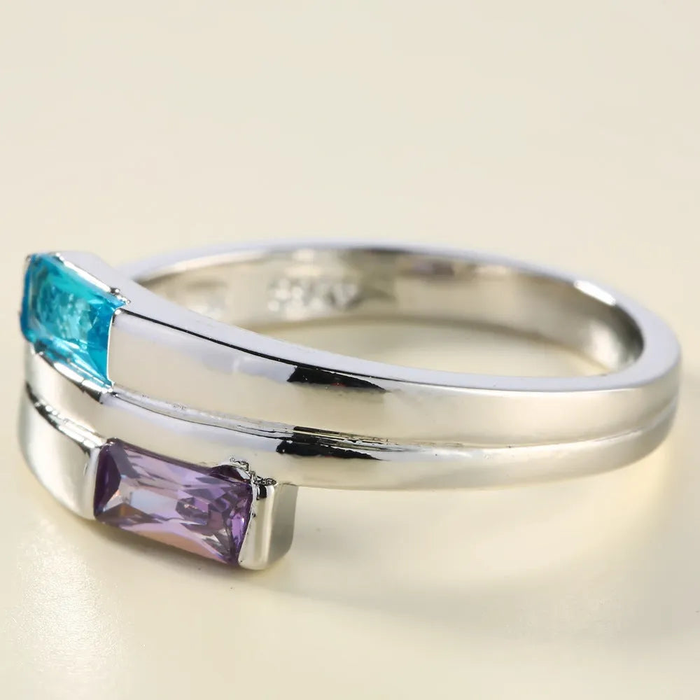 Silver electroplated copper ring with a zircon inlay, shown in a unisex design.