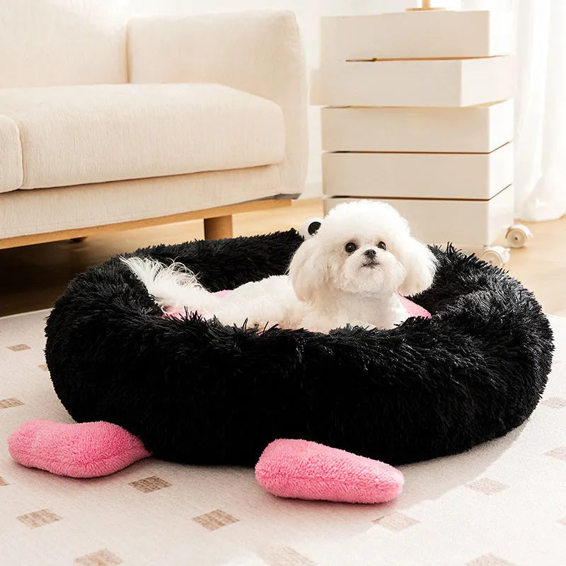 Blue plush kennel sleeping mat for small dog with raised edges, shown on a wooden floor.