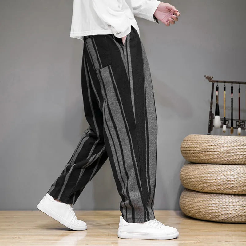 Men's navy blue and black striped wide-leg casual trousers with mid waist, laid flat.