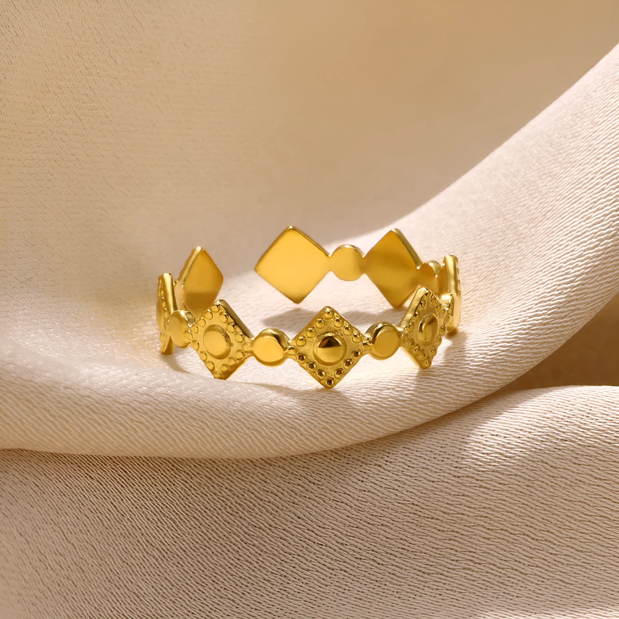 Golden diamond geometric titanium steel women's ring on a hand.